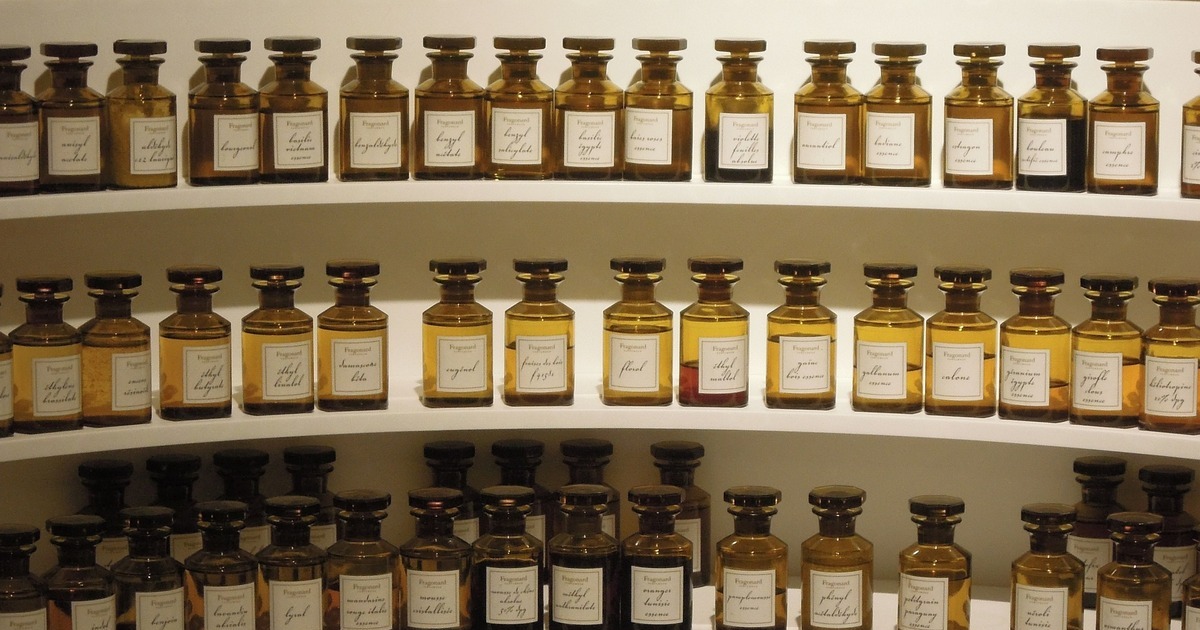 A lot of perfume bottles on a shelf for storage