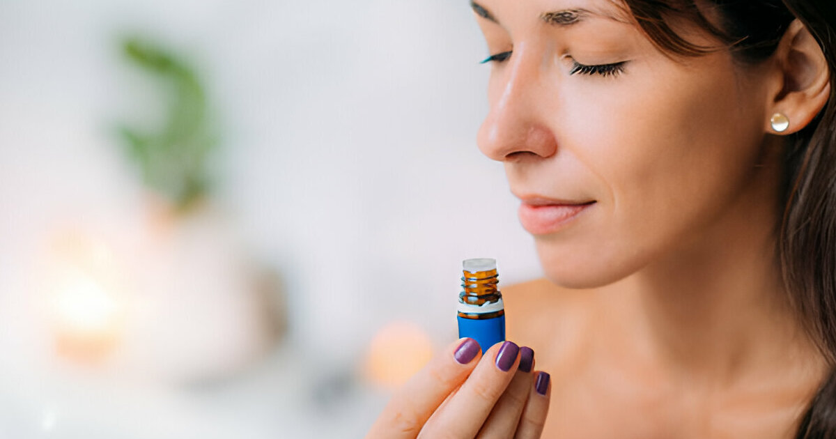 A person checks the scent of a bottle of perfume