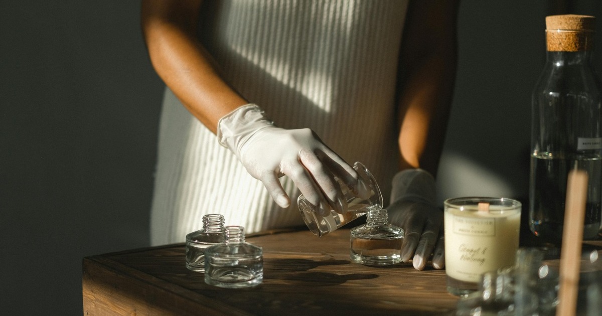 A person is mixing perfume ingredients